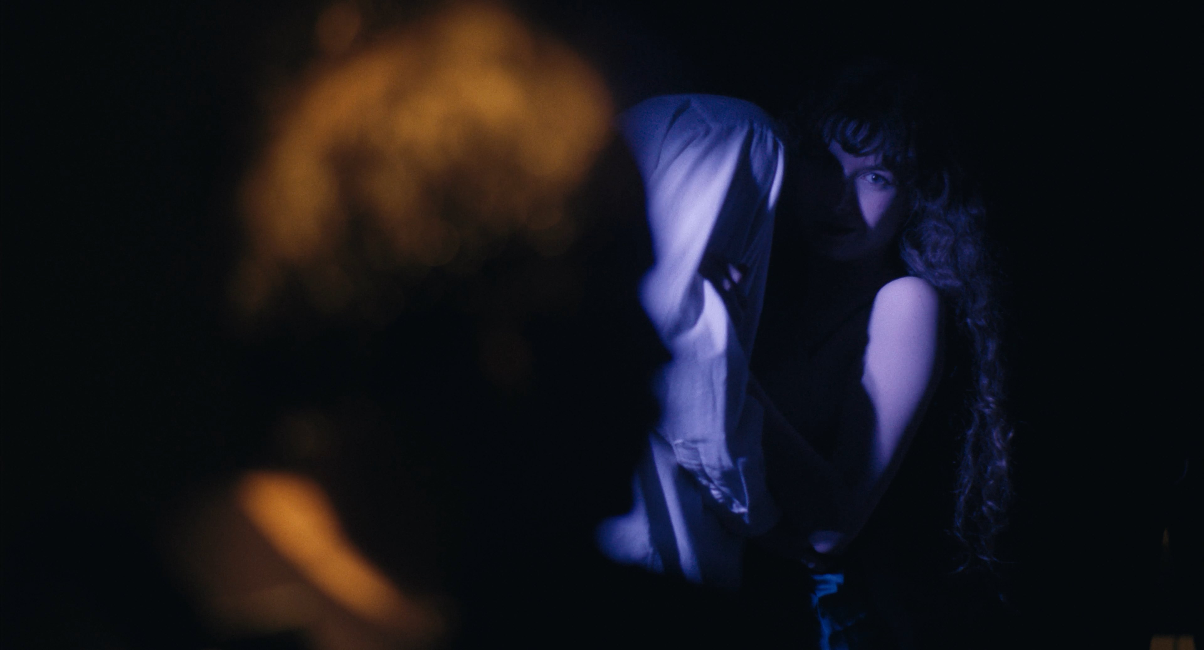 A figure lit in blue and amber in Abyss