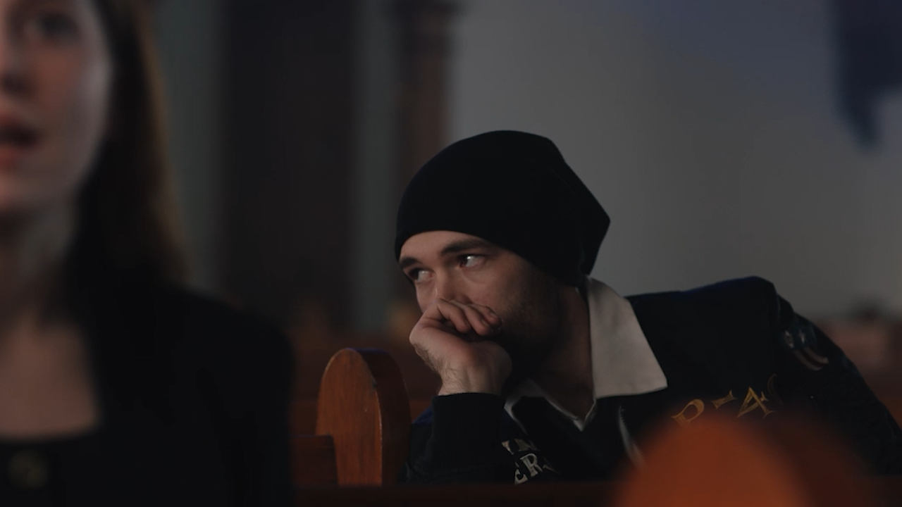 A character seated in a church